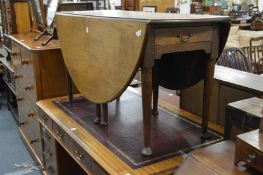 A 19th century oak oval drop leaf gate leg dining table.