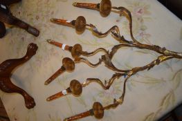 A pair of decorative three branch wall lights.