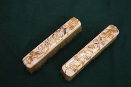 A pair of Shibayama decorated ivory clothes brushes.