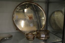 A circular Sheffield plated salver with engraved crest and two plated bottle coasters.