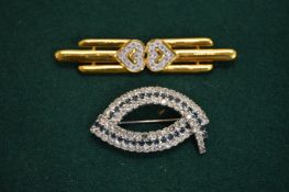 Two decorative brooches.