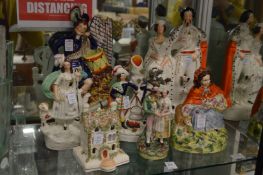 A group of Staffordshire figures to include the Queen and King of Sardinia, a Highlander with drums,