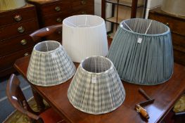 A pair of pleated lampshades and two others.
