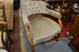 An upholstered horseshoe shaped open armchair.
