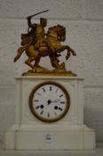 A Victorian marble mantle clock decorated with a knight on horseback.