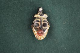 A small Syrian glass pendant.