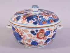 A JAPANESE IMARI PORCELAIN ECUELLE AND COVER, decorated in the typical red and blue imari palette