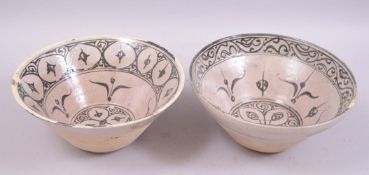 TWO ISLAMIC PARTLY GLAZED POTTERY BOWLS, each similarly painted with stylised motifs, both approx.