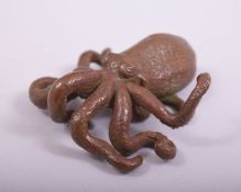 A JAPANESE BRONZE MODEL OF AN OCTOPUS, with large mark to underside, 7cm long.