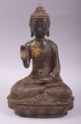 A CHINESE BRONZE MODEL OF A SEATED BUDDHA, with traces of gilt decoration, 24cm high.