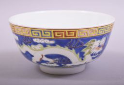 A SMALL CHINESE BLUE GLAZED PORCELAIN DRAGON BOWL, the bowl exterior incised and painted with two