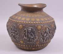 AN INDIAN COPPER BOWL, with applied silver and brass decoration, the main body with oval