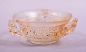 A SMALL CHINESE GLASS CUP, with chilong formed handles to the exterior, 10cm diameter.