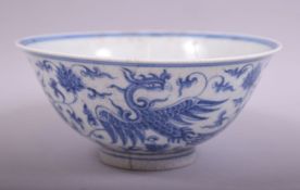 A CHINESE BLUE AND WHITE PORCELAIN PHOENIX BOWL, the exterior painted with phoenix amongst lotus and