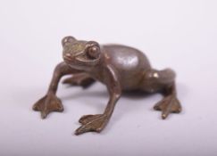 A SMALL JAPANESE BRONZE MODEL OF A FROG, stamped underside, 4cm long.