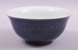 A CHINESE BLUE GLAZED PORCELAIN BOWL, with moulded decoration under glaze, six character mark to