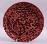 A GOOD CHINESE CINNABAR LACQUER DISH, the centre with two dragons and the flaming pearl of wisdom,