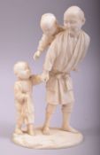 A GOOD JAPANESE MEIJI CARVED IVORY OKIMONO of a man and his children, the figure with a boy on his