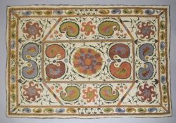 A 19TH CENTURY UZBEKISTAN SUZANI EMBROIDERED TEXTILE, the central with a floral star motif, with