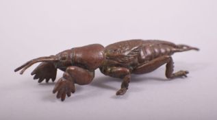 A JAPANESE BRONZE MODEL OF A MOLE CRICKET, stamped underside, 7cm long.