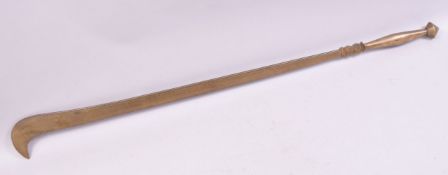 AN UNUSUAL ISLAMIC BRASS SWORD / WEAPON with hooked end, punch decorated and engraved with