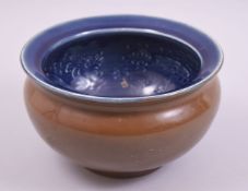 A CHINESE BROWN AND BLUE GLAZED POTTERY DRAGON BOWL, 19cm diameter.