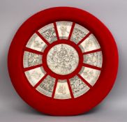 A FINE QUALITY JAPANESE MEIJI PERIOD CARVED IVORY FRAMED SECTIONS OF GODS AND CHILDREN, the mount