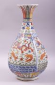 A CHINESE WUCAI OCTAGONAL FORM BALUSTER VASE, decorated with dragons and fish, with six character