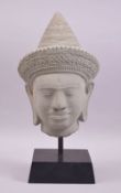 A DECORATIVE 20TH CENTURY THAI CARVED HARDSTONE HEAD, of a man wearing a traditional hat, mounted on