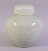 A GOOD CHINESE CELADON PORCELAIN JAR AND COVER, with incised floral decoration under glaze, 19.5cm