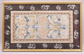 A CHINESE EMBROIDERED TEXTILE PANEL, embroidered with large flower heads, mounted with later