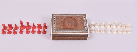 A GOOD RED AND WHITE STAINED IVORY ENGLISH CHESS SET, in a carved Indian box.