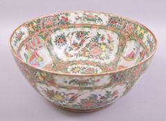A LARGE CHINESE CANTON PORCELAIN BOWL, painted with panels of figures, birds and native flora,