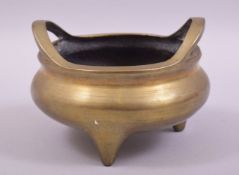 A GOOD CHINESE BRASS TWIN HANDLE TRIPOD CENSER, the base with mark, 14cm diameter.