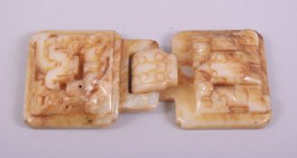 A CHINESE CARVED JADE BUCKLE, with two locking pieces (2).