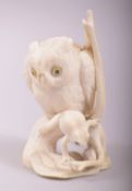 A SUPERB 19TH CENTURY JAPANESE CARVED IVORY OKIMONO of an owl and frog, the owl stood upon a