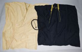 TWO COTTON ARAB ROBES, each gold coloured braiding, together with a woven headband.