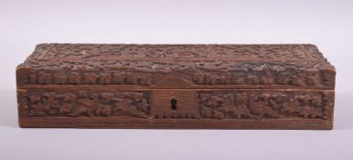 A 19TH CENTURY INDIAN RECTANGULAR CARVED WOOD BOX, carved with temples and animals amongst foliate