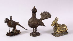 AN INDIAN BRASS NANDI BULL, together with a bird oil lamp and another hanging bird oil lamp, bull
