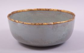 A CHINESE RU WARE PETAL SHAPE BOWL, with gilt rim and calligraphy to base, 18cm diameter.