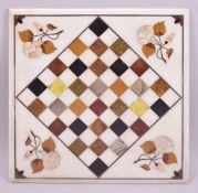 AN ITALIAN SQUARE MARBLE CHESS BOARD, inlaid with specimen marbles with mother of pearl flowers,
