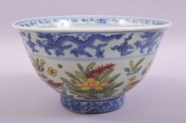 A CHINESE BLUE AND WHITE DOUCAI PORCELAIN BOWL, decorated with ducks and lotus flowers in the doucai
