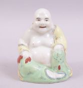 A SMALL PORCELAIN FIGURE OF A SEATED HOTEI, 8cm high.