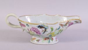 A CHINESE FAMILLE ROSE PORCELAIN SAUCE BOAT, painted with butterflies, flowers and fruit. 24cm