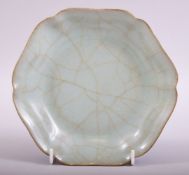 A CHINESE SONG STYLE CELADON LONGQUAN DISH, the base with calligraphy, 17.5cm diameter.