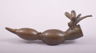 A JAPANESE BRONZE MODEL OF A DRAGONFLY ON A LOTUS ROOT, stamped underside, 9cm long.