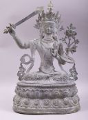 A LARGE BRONZE FIGURE OF A DEITY HOLDING A SWORD, 38cm high.