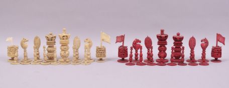 A 19TH CENTURY BURMESE STAINED RED AND WHITE IVORY CHESS SET, king 8cm, queen 7.5cm.