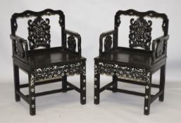 A GOOD PAIR OF CHINESE CARVED HARDWOOD CHAIRS, inlaid with mother of pearl, with well carved bat