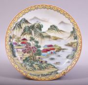 A CHINESE FAMILLE VERTE PORCELAIN DISH, the dish painted with a landscape scene with buildings and